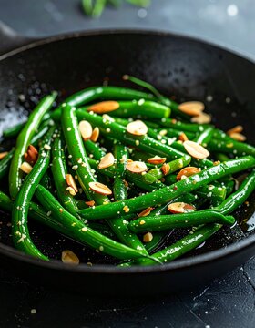 Green beans saut&eacute;ing in a skillet with garlic and almonds, vibrant color