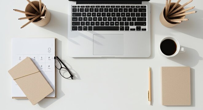 Modern white office desk with minimalist decor and stationery setup.