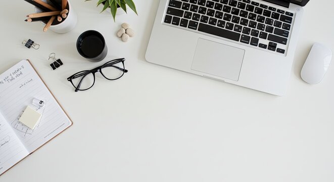 Minimalist workspace with laptop and decorative elements on desk.