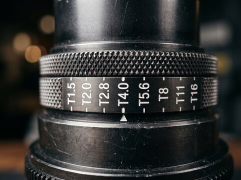 Macro photo of cinema camera lens showing aperture T stop numerical scale markings