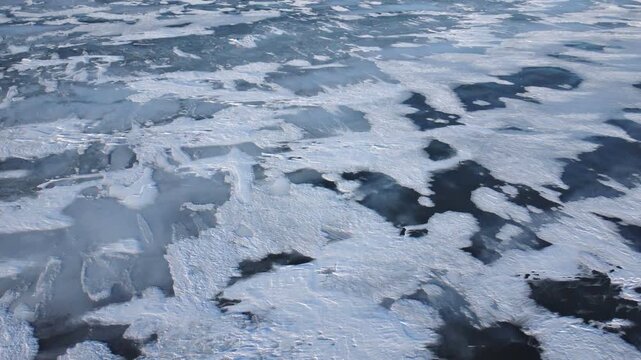 Flying low over Lake St. Clair, a minor Great Lake on the border of Michigan, United States and Ontario, Canada. This shallow lake freezes over regularly and is a popular spot for winter recreation.