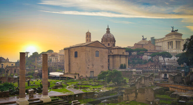 Roman Forum and Curia Julia in Rome against dramatic golden sunrise with copy space