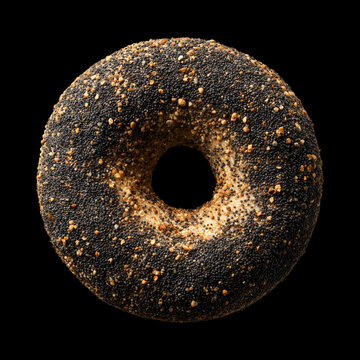 Closeup of a poppy seed covered bagel isolated on a black background with clipping path, representing fresh bakery food