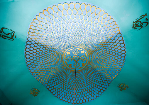 Dhaka, Bangladesh - 20 September 2024: View of the intricate gold and turquoise patterned dome interior of a mosque in Dhaka.