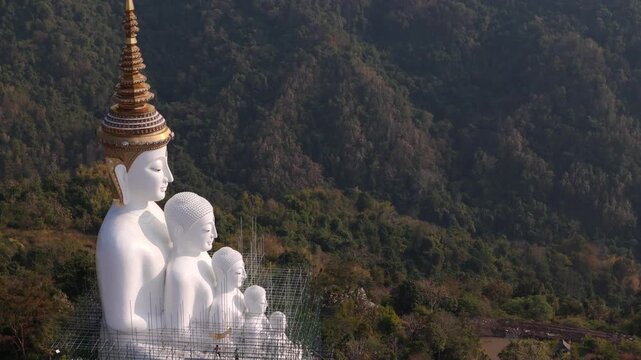 Aerial view of Wat Phra That Pha Son Kaew temple and the iconic five white Buddha statues in Khao Kho, Thailand