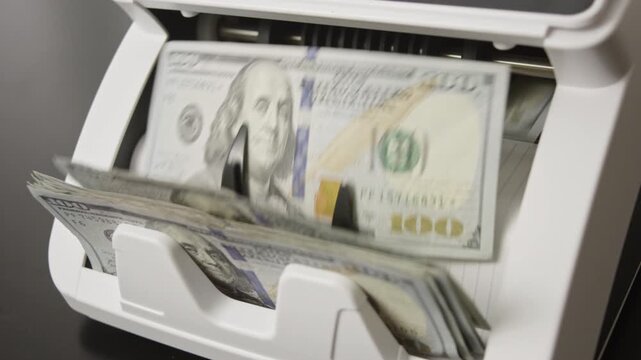 Money counting machine with motion bills. Money counting process. Counting paper money bills. Banking and cash concept. Savings dollars theme.