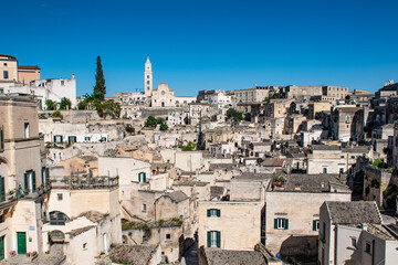 he enchanting city of Matera, Italy, bathed in bright sunlight. Known for its ancient cave dwellings and stunning architecture © Wolf Sichalek