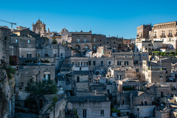 the enchanting city of Matera, Italy, bathed in bright sunlight. Known for its ancient cave dwellings and stunning architecture © Wolf Sichalek