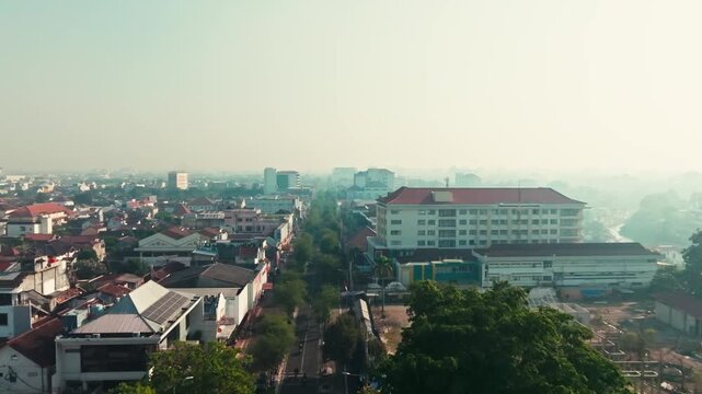 Hazy aerial view along an urban avenue in Yogyakarta