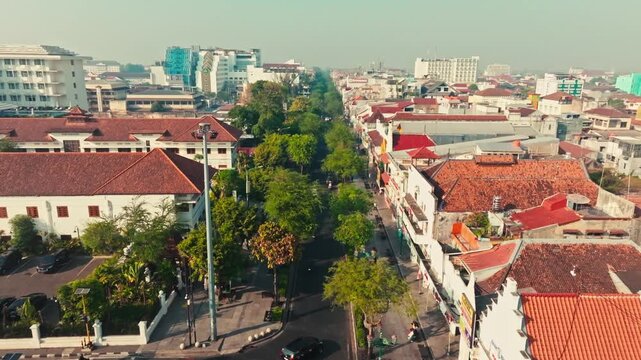 Elevated Yogyakarta cityscape with busy avenue and historic rooftops