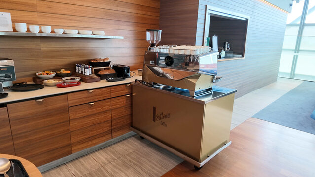 Professional Espresso Machine and Breakfast Station in a Modern Hotel Lounge