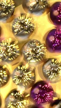 Vertical macro of colorful christmas baubles glowing with internal lights