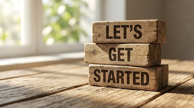 Wooden blocks with Lets Get Started text on a rustic wood texture background