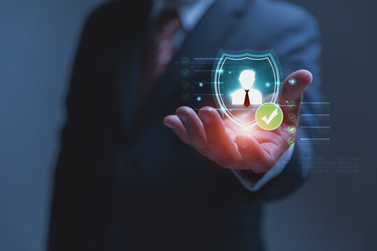 A professional businessman holds out his hand to display a glowing digital security shield, representing the safety and protection of sensitive personal data.