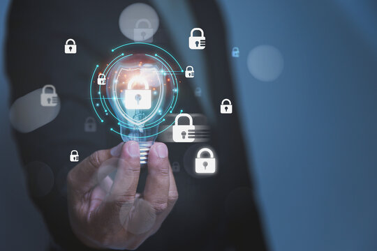 Businessman holding a glowing lightbulb with Digital shield and padlock icons, representing advanced cybersecurity and privacy protection.