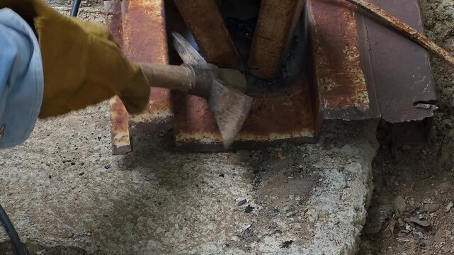 Chipping and Cleaning Welding Slag Off Rusty Iron Base Structure