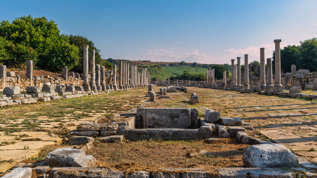 Ancient ruins of the Columned Main Street in the historic city of Perge, Antalya, Turkey. This well-preserved archaeological site showcases rows of stone columns along an ancient road