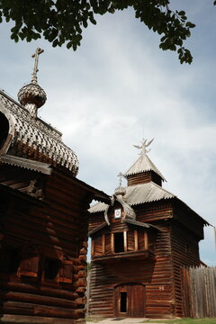 Historic Russian log churches against cloudy sky