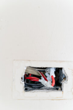 Dangerous exposed wiring in a wall outlet