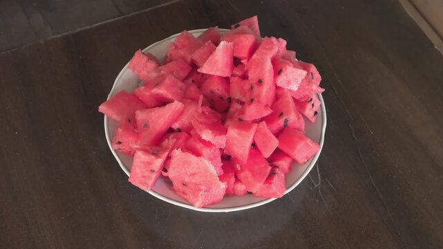 pricking watermelon slices with fork, slow motion
