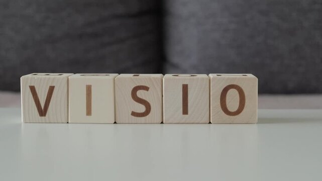 vision, motivational word, laying out  by hand from letters on wooden cubes, slow motion
