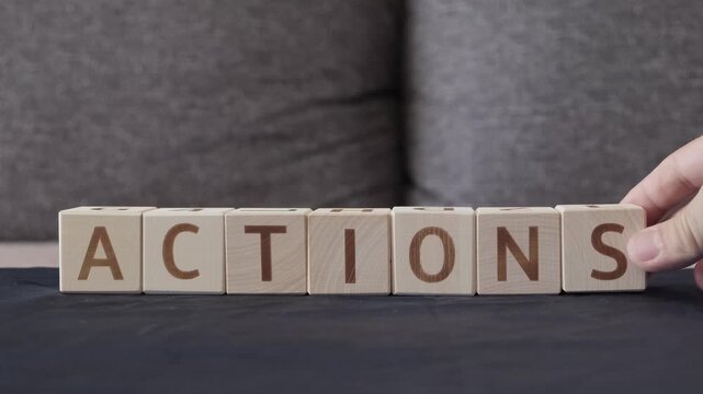 actions, motivational word, laying out  by hand from letters on wooden cubes, slow motion

