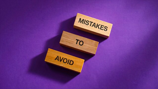 Wooden blocks showing mistakes to avoid as a concept for learning and business improvement