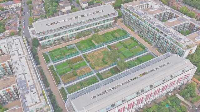 Aerial drone footage of Highbury Stadium, the former home of Arsenal Football Club, now redeveloped into the Highbury Stadium Square residential apartments in North London, England.
