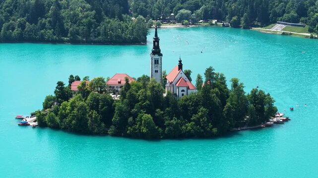 Drone Shot of Lake Bled Island and Catholic Church Surrounded With Aqua Blue Glacial Water, Slovenia