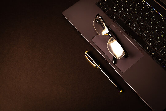Glasses on laptop keyboard. Business and technology concept.