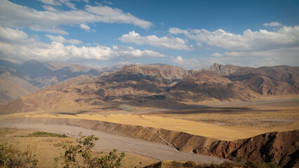 Panoramic view of vast Panj river valley and arid mountains in Badakhshan along Pamir Highway © Nail