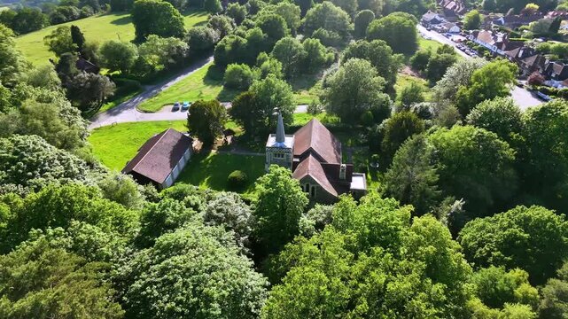 Aerial view of St Andrew's Church, Limpsfield Chart, with trees and village