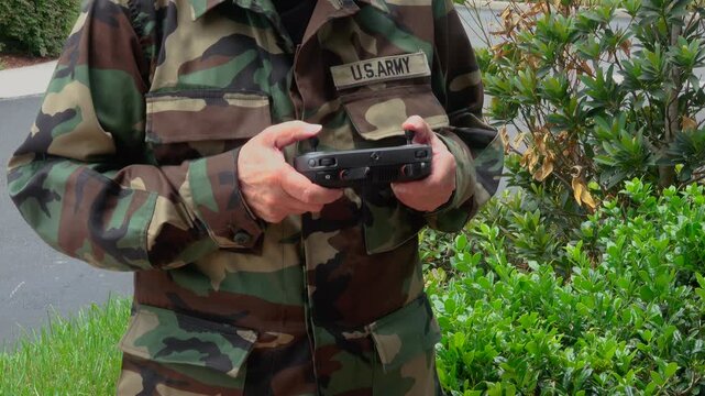 Military Soldier Operating UAV Drone Controller for Battlefield Reconnaissance and Tactical Surveillance