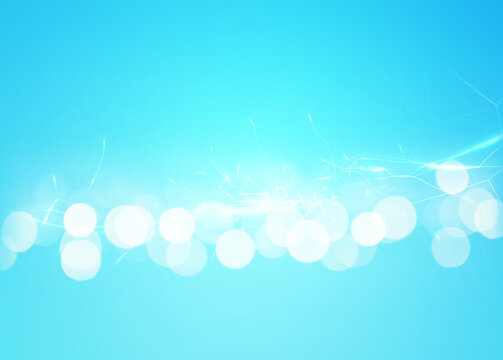 Abstract background of light blue shades with glare and bokeh effect.