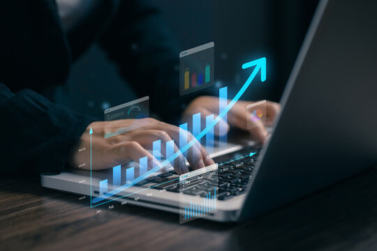 Business professional using laptop with virtual growth charts and rising arrow, illustrating financial analytics, business performance, data strategy, investment, and digital growth.