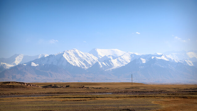 High altitude mountain landscape with snowy glaciers and autumn steppe in Osh region, Kyrgyzstan