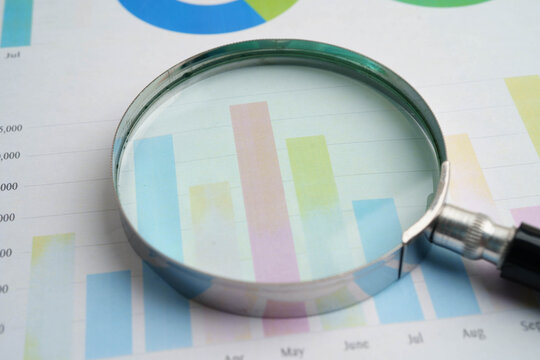 Magnifying glass on charts graphs paper. Financial development, Banking Account, Statistics, Investment Analytic research data economy.