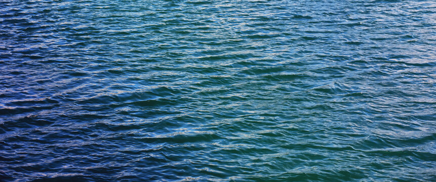 Water surface. The texture of the water. Waves on the lake in windy weather.