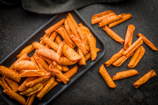 Crispy Spicy Taquitos Pile on Dark Surface Close-Up, Mexican Rolled Corn Snack