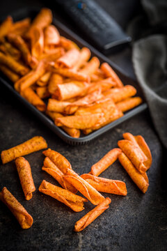 Crispy Spicy Taquitos Pile on Dark Surface Close-Up, Mexican Rolled Corn Snack