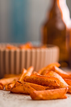 Crispy Seasoned Potato Fries With Spicy Paprika Coating On Kitchen Counter