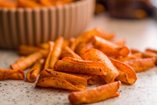 Crispy Seasoned Potato Fries With Spicy Paprika Coating On Kitchen Counter