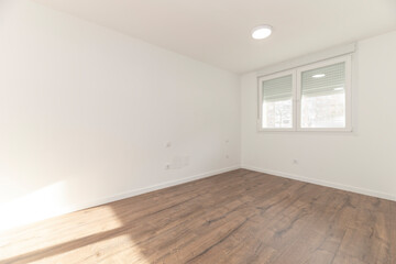 Fototapeta premium Empty Room with Corner View, Twin-Pane Window Overlooking Buildings, and Wood Laminate Flooring