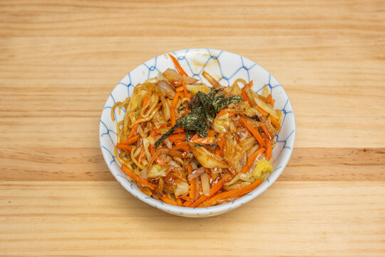Yakisoba Noodles with Carrots, Cabbage, and Nori in Blue Patterned Bowl