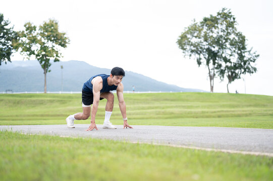 Athletic Asian Man Starting Outdoor Sprint