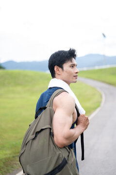 Athletic Asian Man Carrying Backpack After Outdoor Run