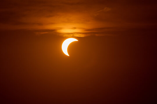 solar eclipse the moon obscures the sun sunset in the mountains