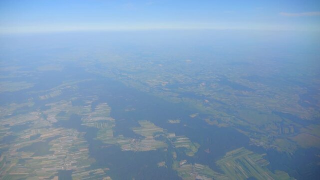 Panoramic aerial view of the earth and clouds, flying above the horizon in 4K slow motion 120fps