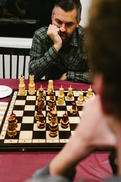 Man contemplates his next move in chess game