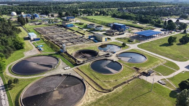Circular clarifier tanks under warm sunset light